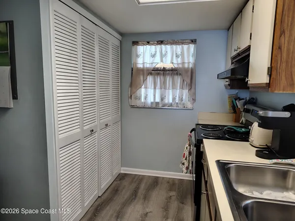 a kitchen with a refrigerator and a sink