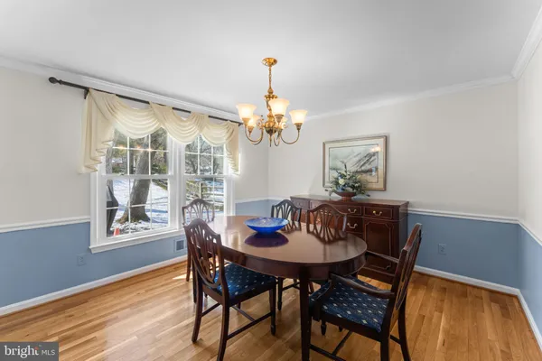 a dining room with furniture and wooden floor
