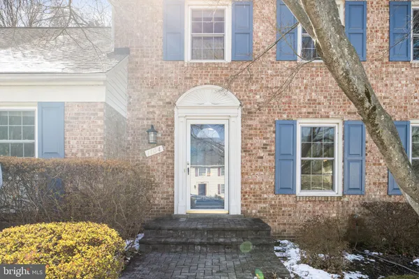 a view of a house with a yard covered in snow