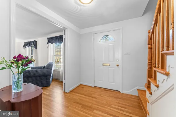 a dining room with furniture a chandelier and wooden floor