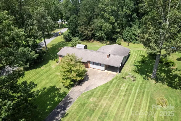 an aerial view of a house with a yard