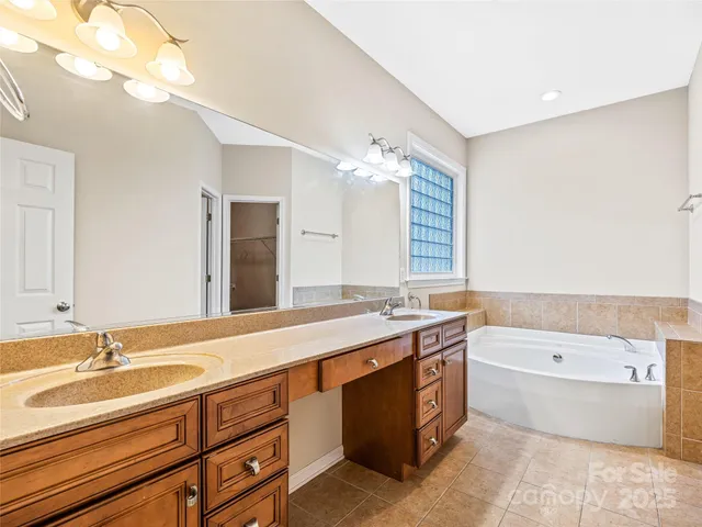 a bathroom with bathtub and window