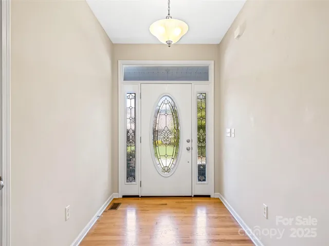 an empty room with window wooden floor and window