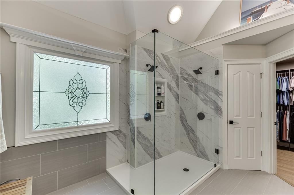 2758 Pathview Drive Dacula, GA 30019 - Photo 6 of 48 a bathroom with a glass shower door and a window