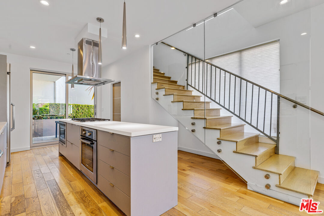 809 Brooks Avenue Venice, CA 90291 - Photo 12 of 32 a kitchen with kitchen island a counter top space a sink and stainless steel appliances