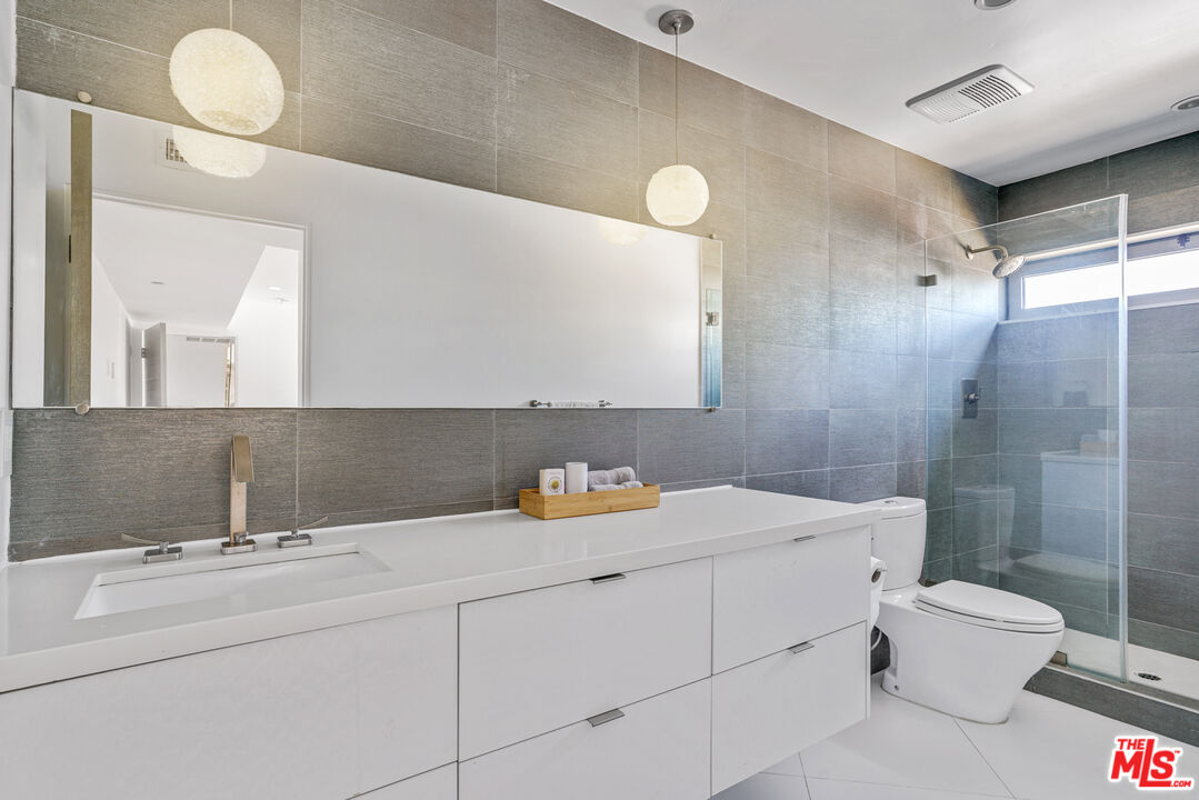 809 Brooks Avenue Venice, CA 90291 - Photo 22 of 32 a bathroom with a sink mirror toilet and shower