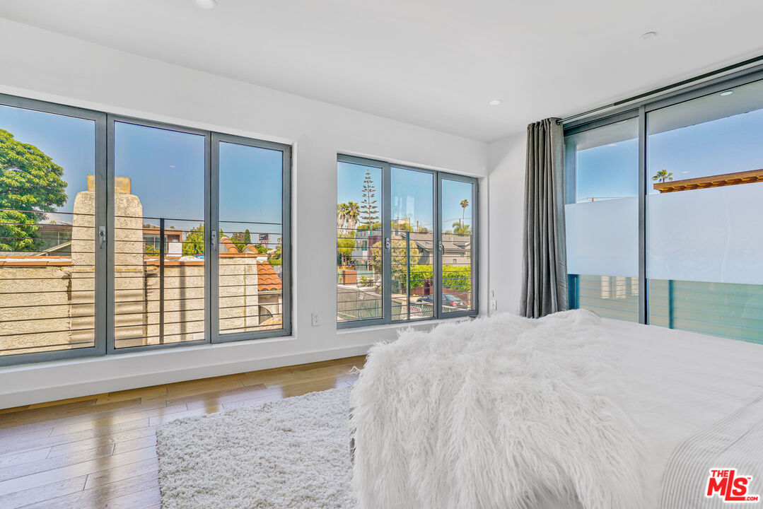 809 Brooks Avenue Venice, CA 90291 - Photo 25 of 32 a view of a bedroom with wooden floor and a window