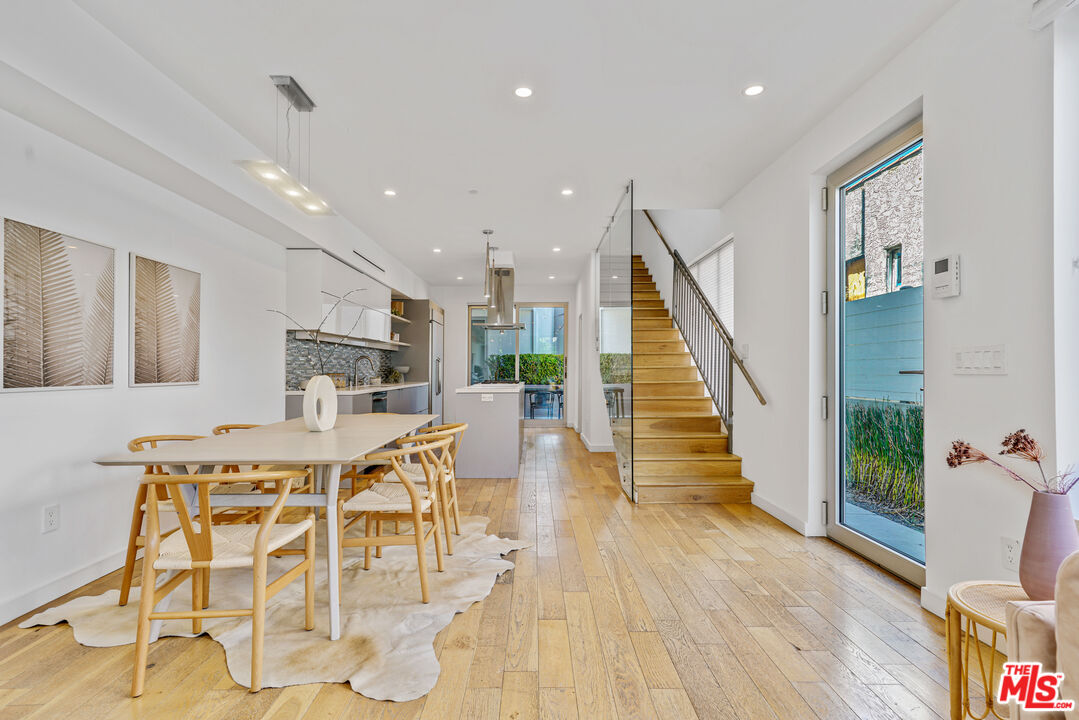809 Brooks Avenue Venice, CA 90291 - Photo 5 of 32 a view of a dining room with furniture wooden floor and a chandelier