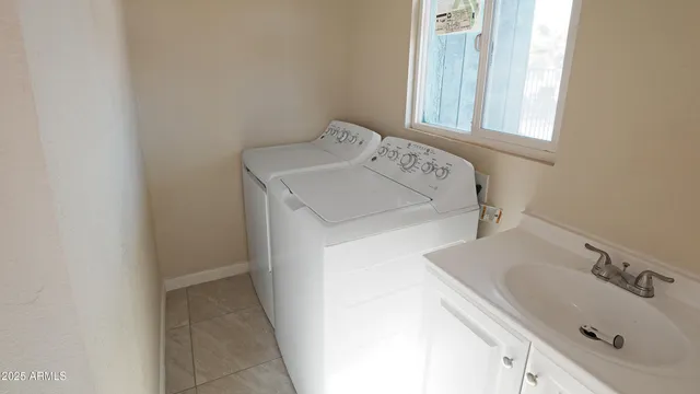 a utility room with a sink washer and dryer