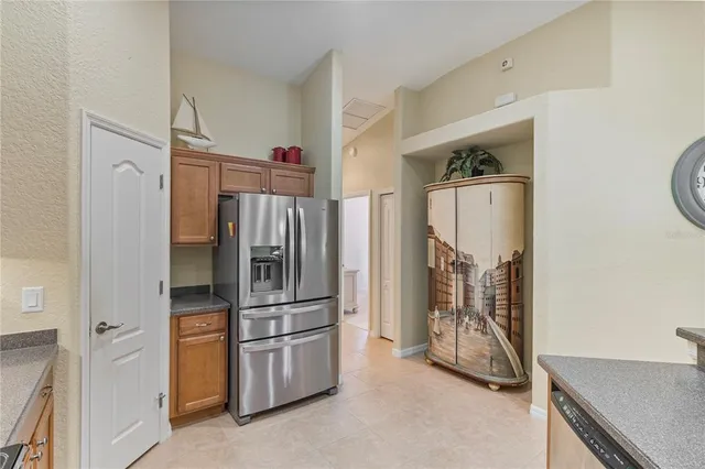 a kitchen with stainless steel appliances a refrigerator and a stove top oven