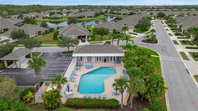 an aerial view of multiple houses with a yard