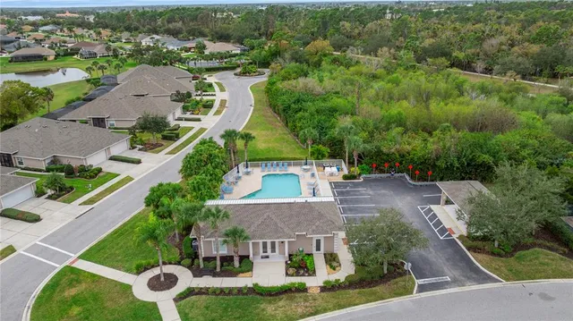 an aerial view of a house with garden space and street view