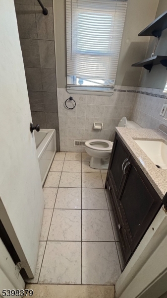 1315 Biscayne Boulevard Union, NJ 07083 - Photo 6 of 7 a bathroom with a granite countertop sink toilet and washing machine