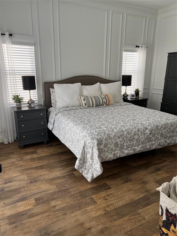 7352 Southeast Seagate Lane Stuart, FL 34997 - Photo 12 of 19 a bedroom with a bed and wooden floor