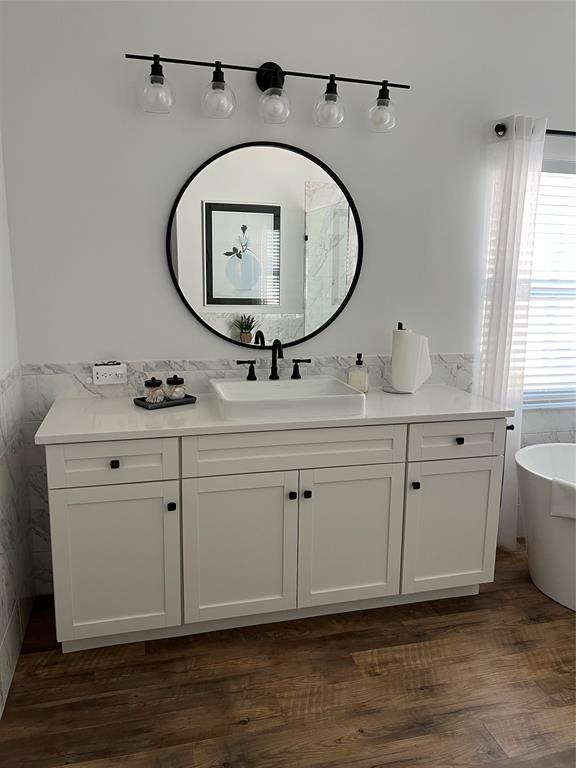 7352 Southeast Seagate Lane Stuart, FL 34997 - Photo 16 of 19 a bathroom with a sink mirror and vanity