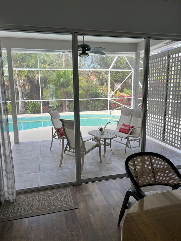 7352 Southeast Seagate Lane Stuart, FL 34997 - Photo 18 of 19 a living room with furniture and a floor to ceiling window