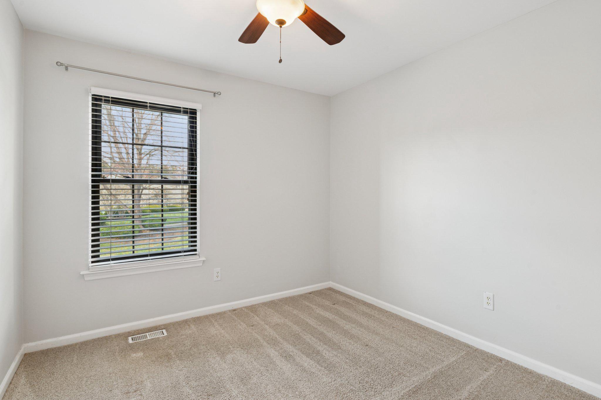 237 McIntosh Road, Unit 82 West Chester, PA 19382 - Photo 12 of 18 an empty room with a window and ceiling fan