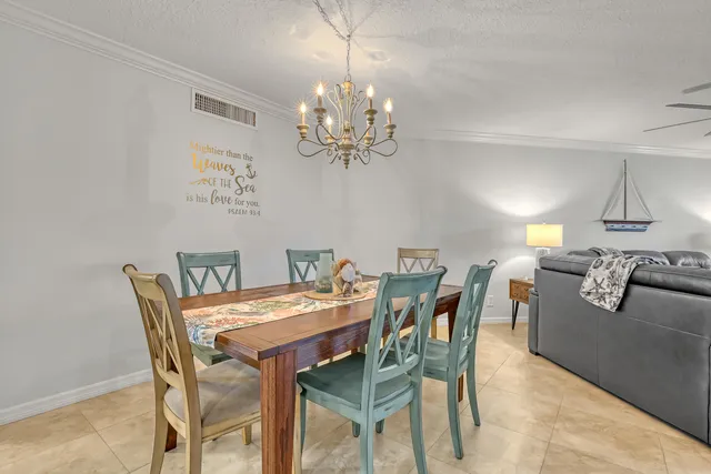 a living room with furniture a rug and a chandelier