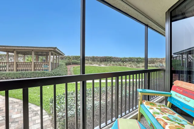 a view of a house with a small deck and wooden floor