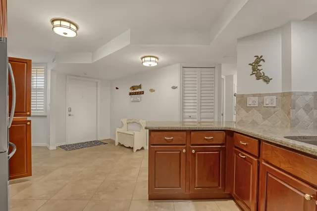 a kitchen with granite countertop a sink stainless steel appliances and cabinets