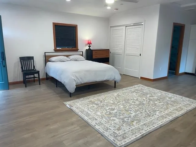 a bedroom with a bed and a flat screen tv