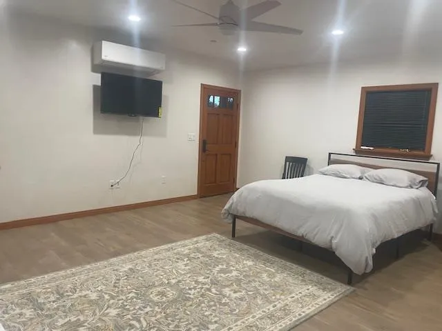 a bedroom with a bed and a flat screen tv