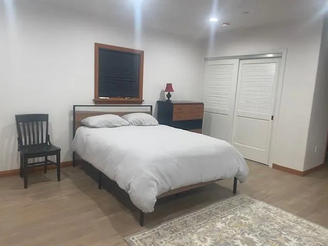 a bedroom with a bed and a chair