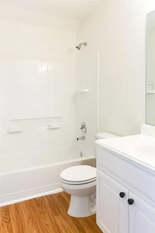 a bathroom with a white toilet and a shower