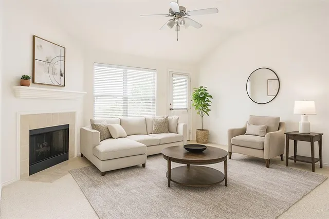 a living room with furniture a table and a fireplace