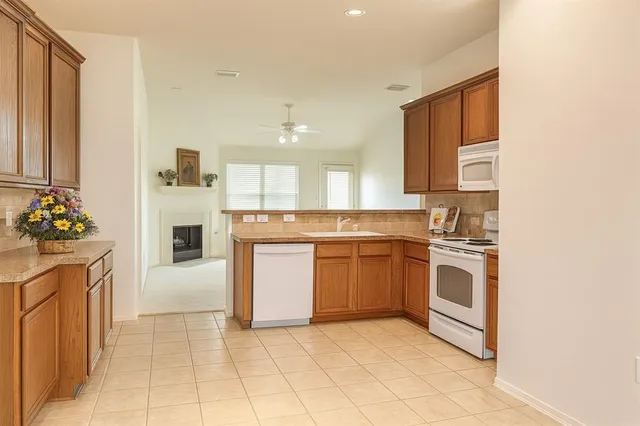 a kitchen with stainless steel appliances granite countertop a stove and a sink