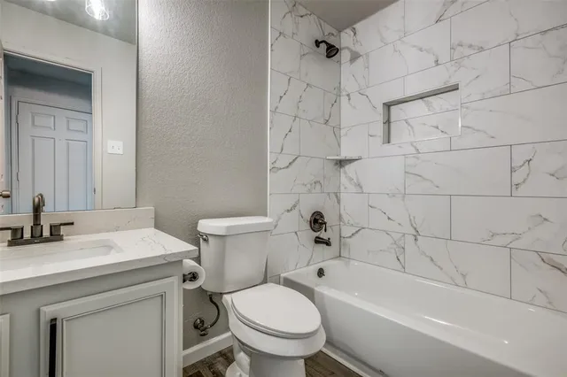 a bathroom with a sink toilet and shower