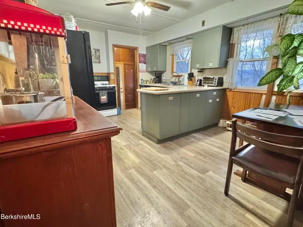 a kitchen with a sink appliances and cabinets