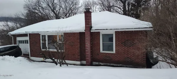 a front view of a house with garage
