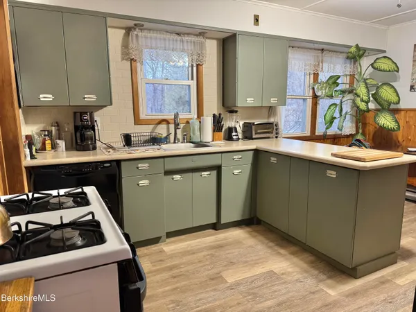 a kitchen with a sink stove and cabinets