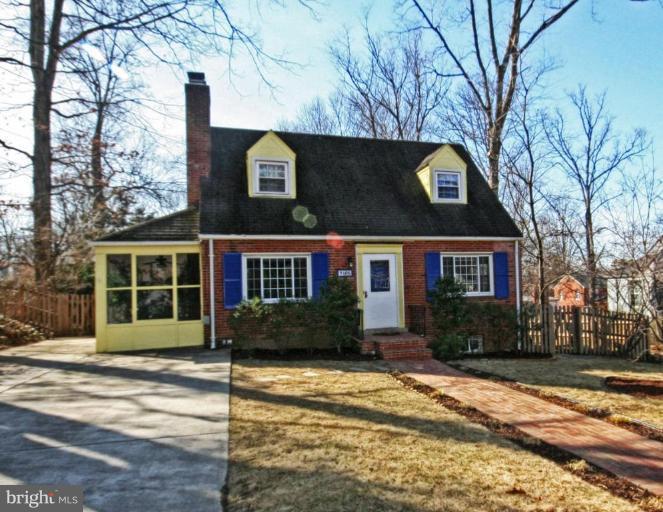 9106 Bradford Road Silver Spring, MD 20901 - Photo 1 of 18 a front view of a house with a yard and garage