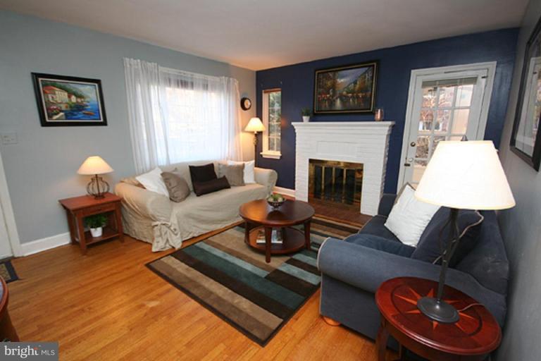 9106 Bradford Road Silver Spring, MD 20901 - Photo 2 of 18 a living room with furniture fireplace and window