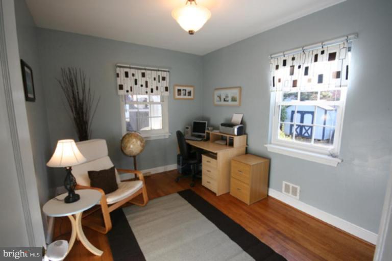 9106 Bradford Road Silver Spring, MD 20901 - Photo 11 of 18 a living room with furniture piano and a window