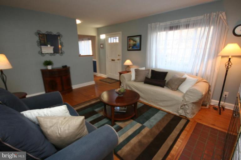9106 Bradford Road Silver Spring, MD 20901 - Photo 3 of 18 a living room with furniture and a large window