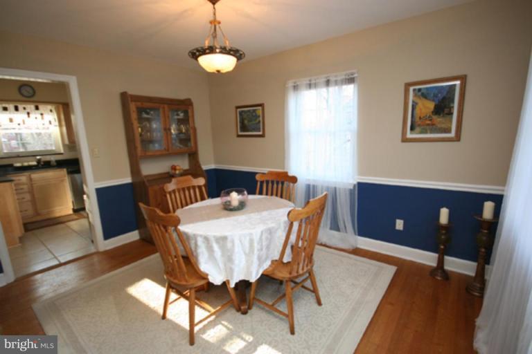 9106 Bradford Road Silver Spring, MD 20901 - Photo 4 of 18 a view of a dining room with furniture window and wooden floor