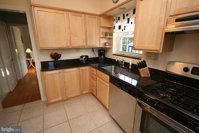 9106 Bradford Road Silver Spring, MD 20901 - Photo 5 of 18 a kitchen with granite countertop a stove sink and cabinets