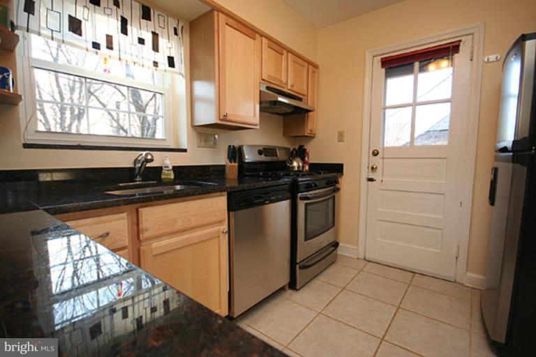 9106 Bradford Road Silver Spring, MD 20901 - Photo 7 of 18 a kitchen with a sink stove and cabinets
