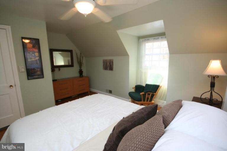 9106 Bradford Road Silver Spring, MD 20901 - Photo 9 of 18 a bedroom with a bed and a lamp