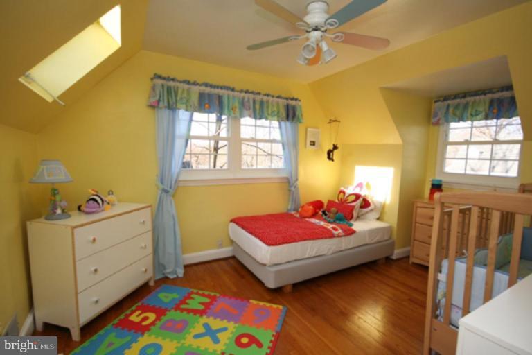 9106 Bradford Road Silver Spring, MD 20901 - Photo 10 of 18 a bedroom with a bed and a dresser