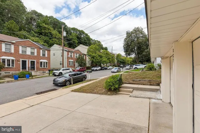 a view of a street with cars parked