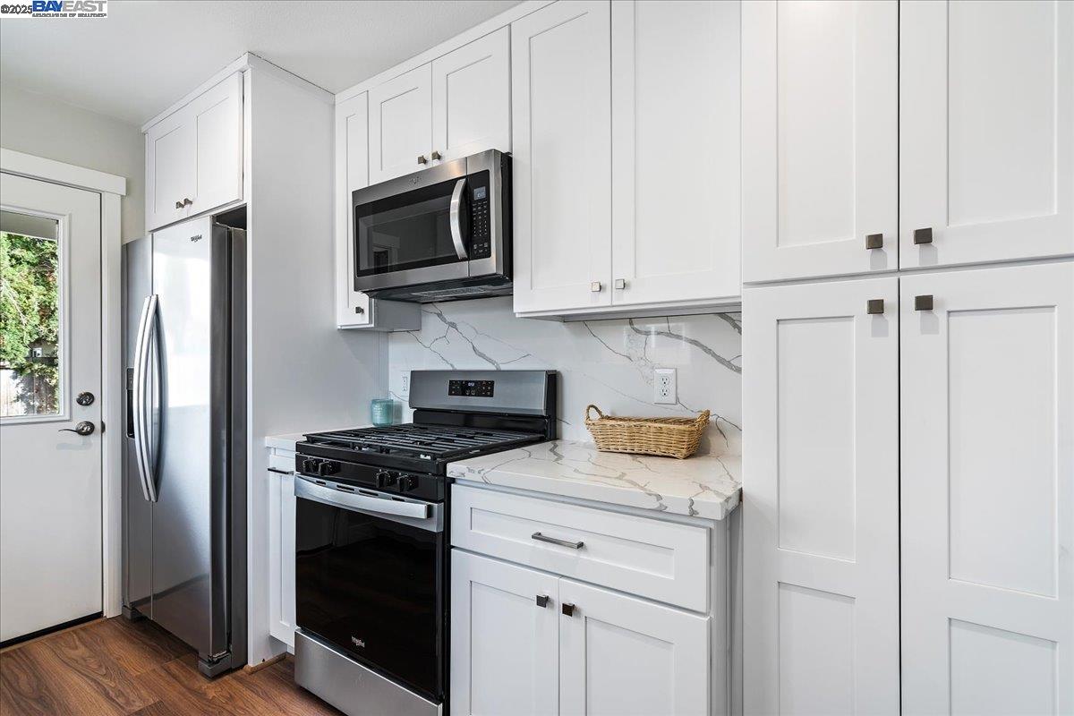 1154 Tilson Drive Concord, CA 94520 - Photo 12 of 25 a kitchen with stainless steel appliances granite countertop white cabinets and a stove a oven with white countertops