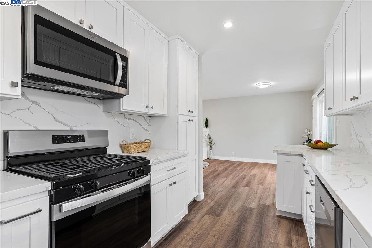 1154 Tilson Drive Concord, CA 94520 - Photo 14 of 25 a kitchen with stainless steel appliances a stove microwave and cabinets