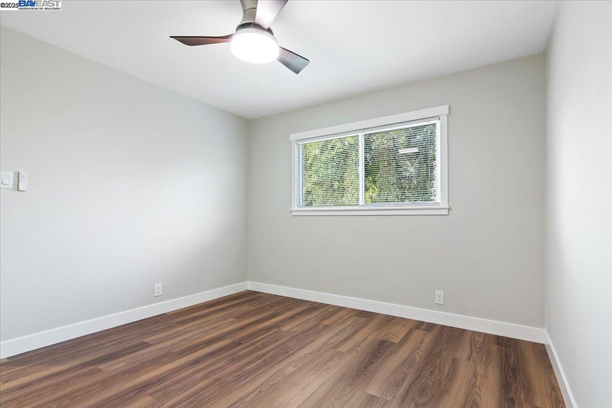 1154 Tilson Drive Concord, CA 94520 - Photo 18 of 25 a view of an empty room with wooden floor and a window