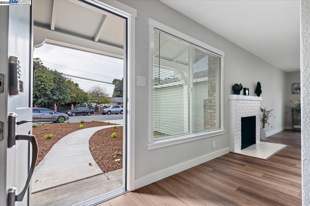1154 Tilson Drive Concord, CA 94520 - Photo 3 of 25 a view of a living room with a fireplace and a floor to ceiling window