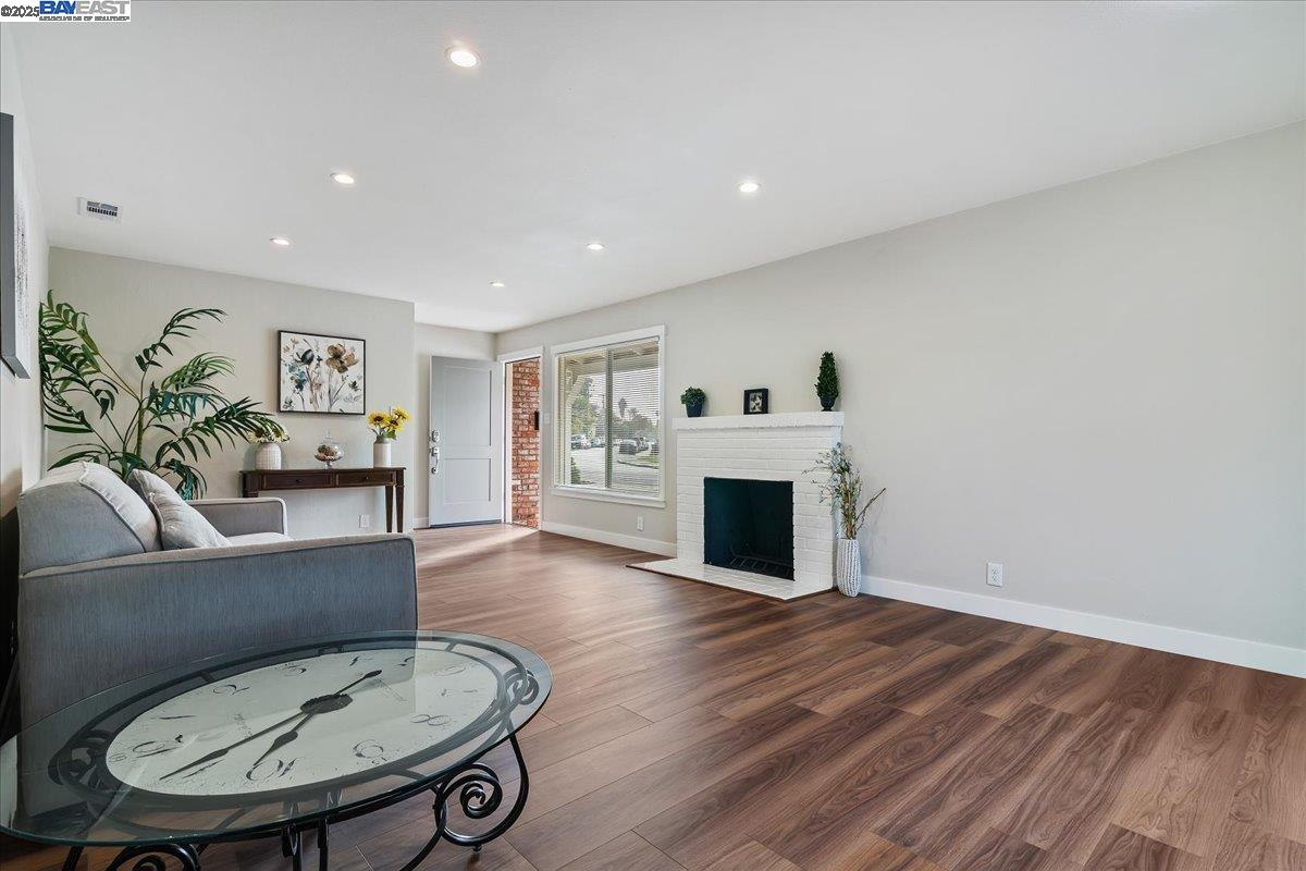 1154 Tilson Drive Concord, CA 94520 - Photo 8 of 25 a living room with furniture a fireplace and a table