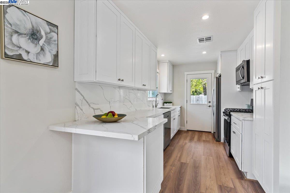 1154 Tilson Drive Concord, CA 94520 - Photo 10 of 25 a kitchen with a refrigerator and a stove top oven